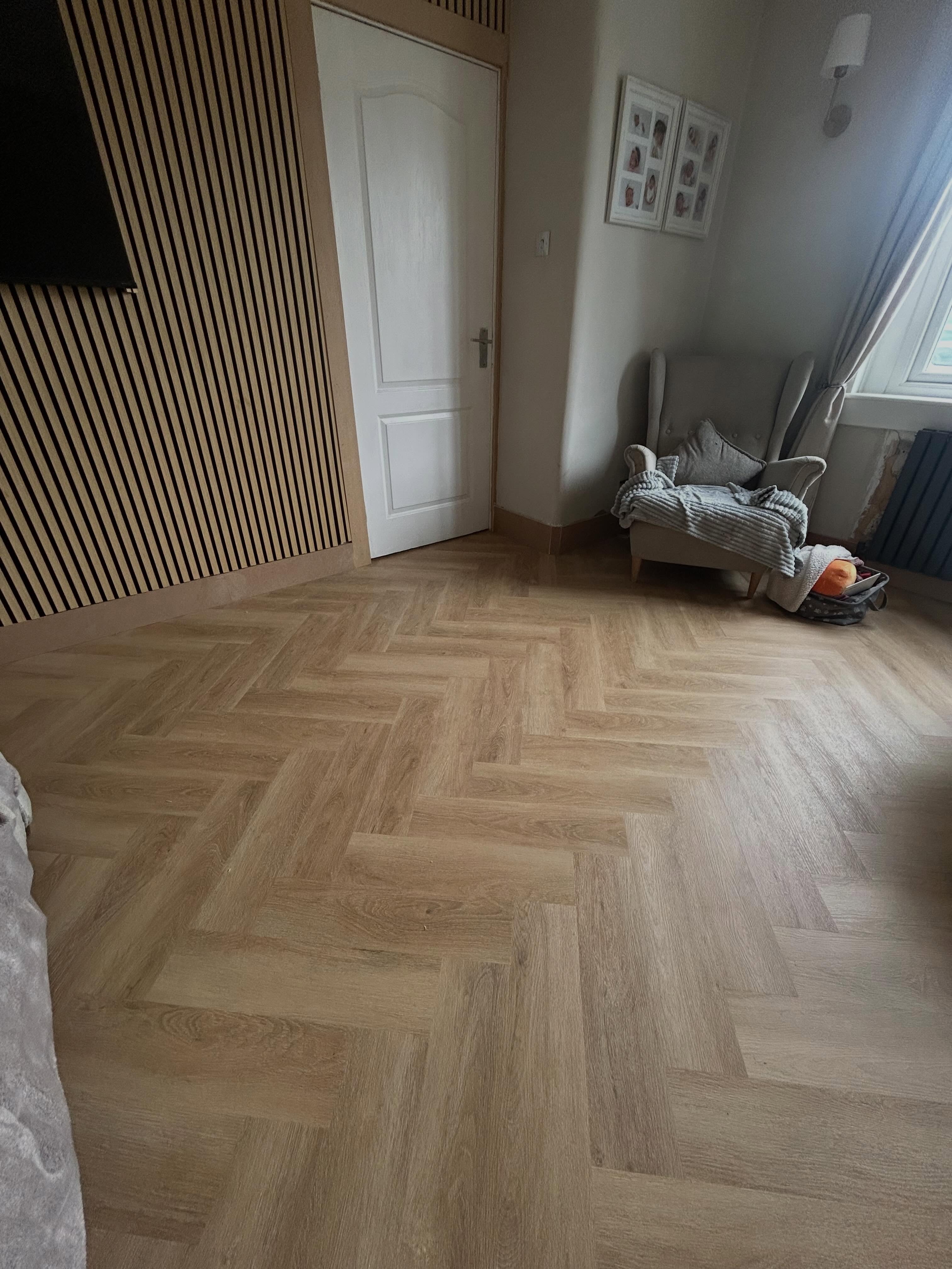 Close-up of herringbone floor pattern with skirting boards